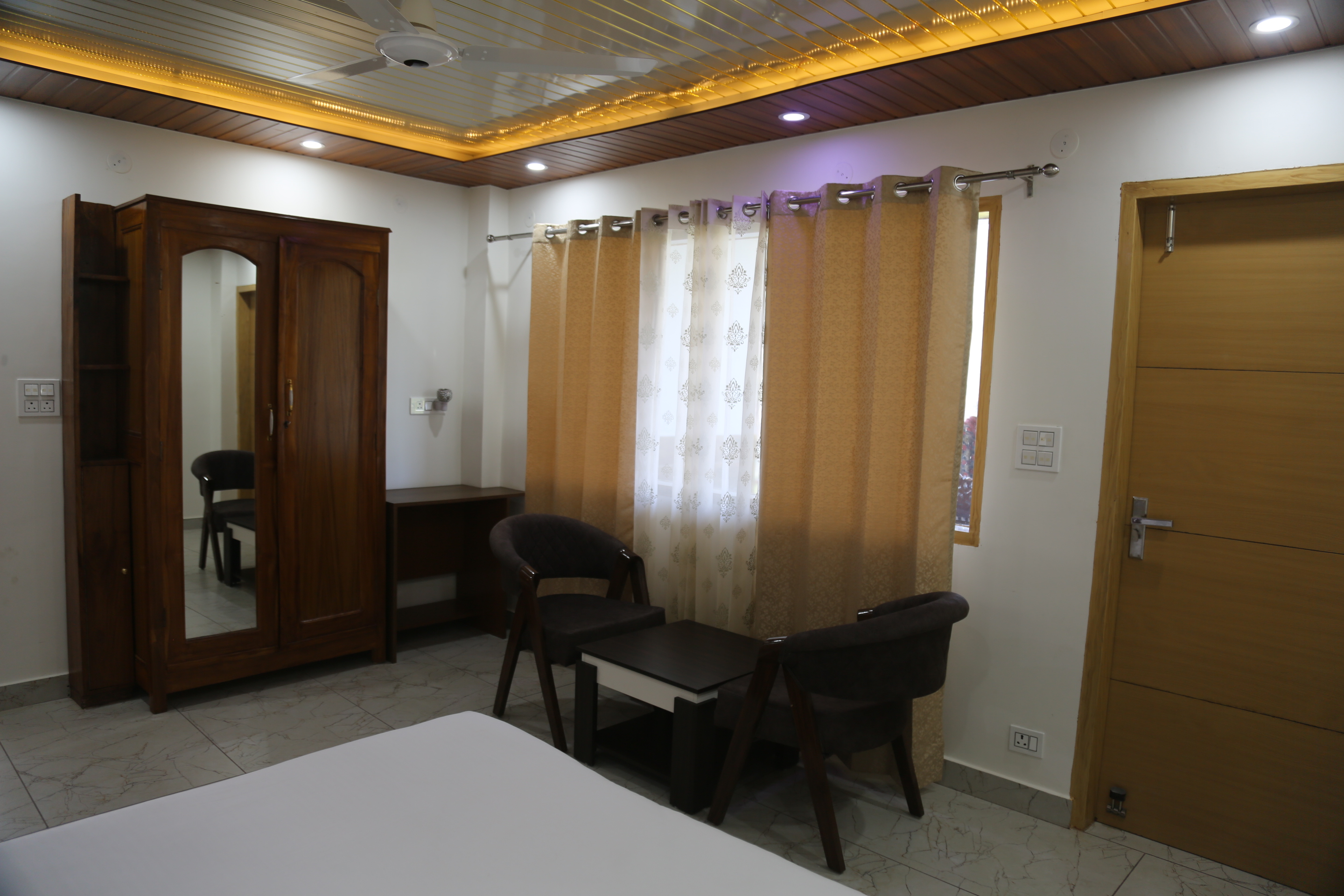 Short stay room bed and seating at Hotel Kuber Residency Dwarka Sector 9